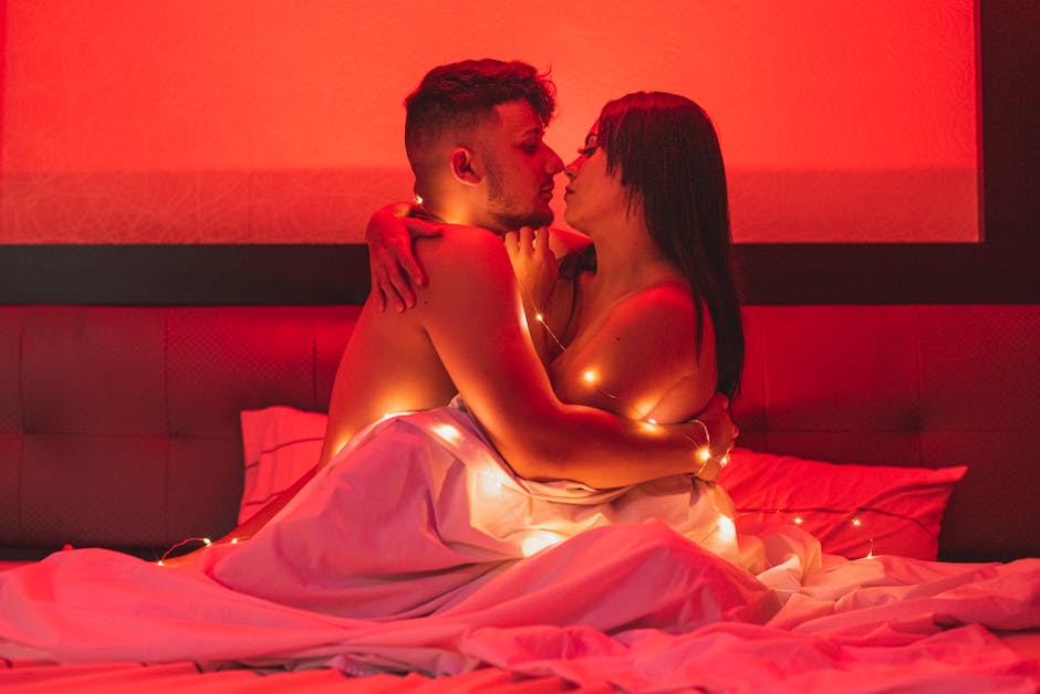 Romantic couple in moody red light during an intimate portrait session