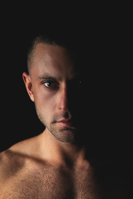 Moody male boudoir portrait with warm directional light